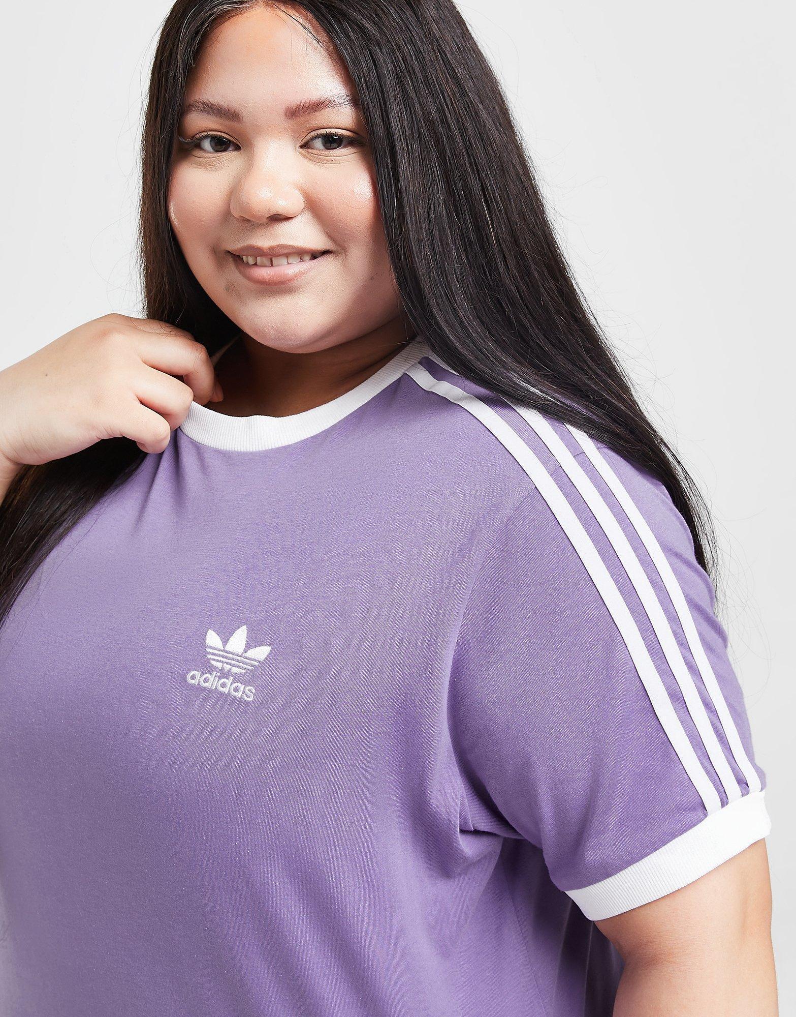En person i lila t-shirt från adidas Originals