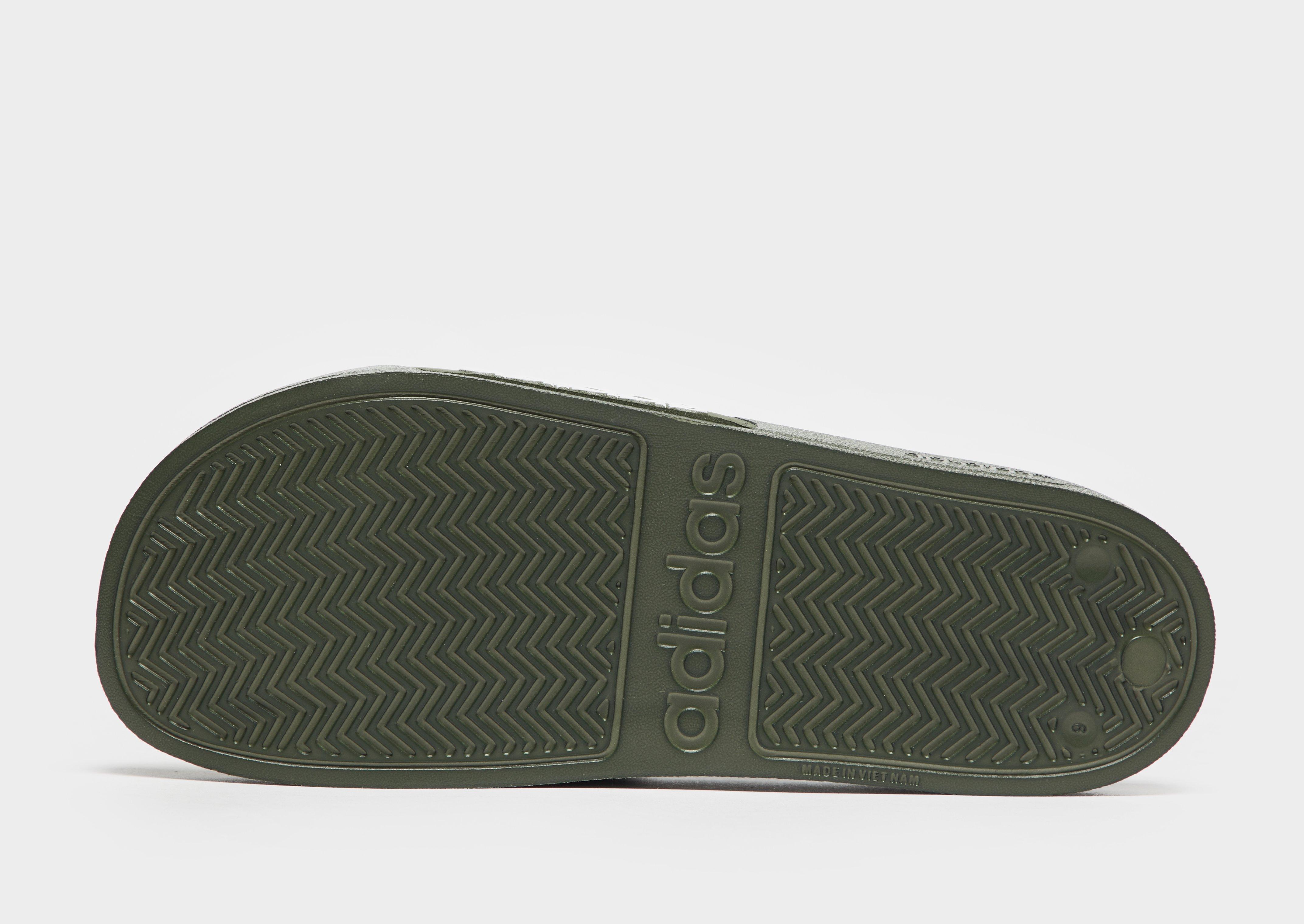 green and black adidas slides