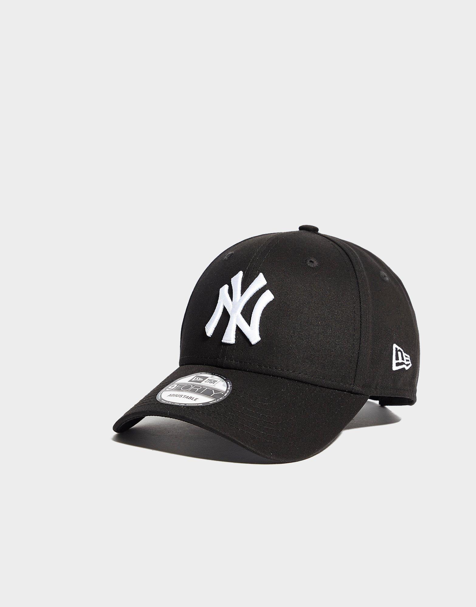 Black Nike Sneaker with Black New Era New York Yankees Cap Stock Photo -  Alamy