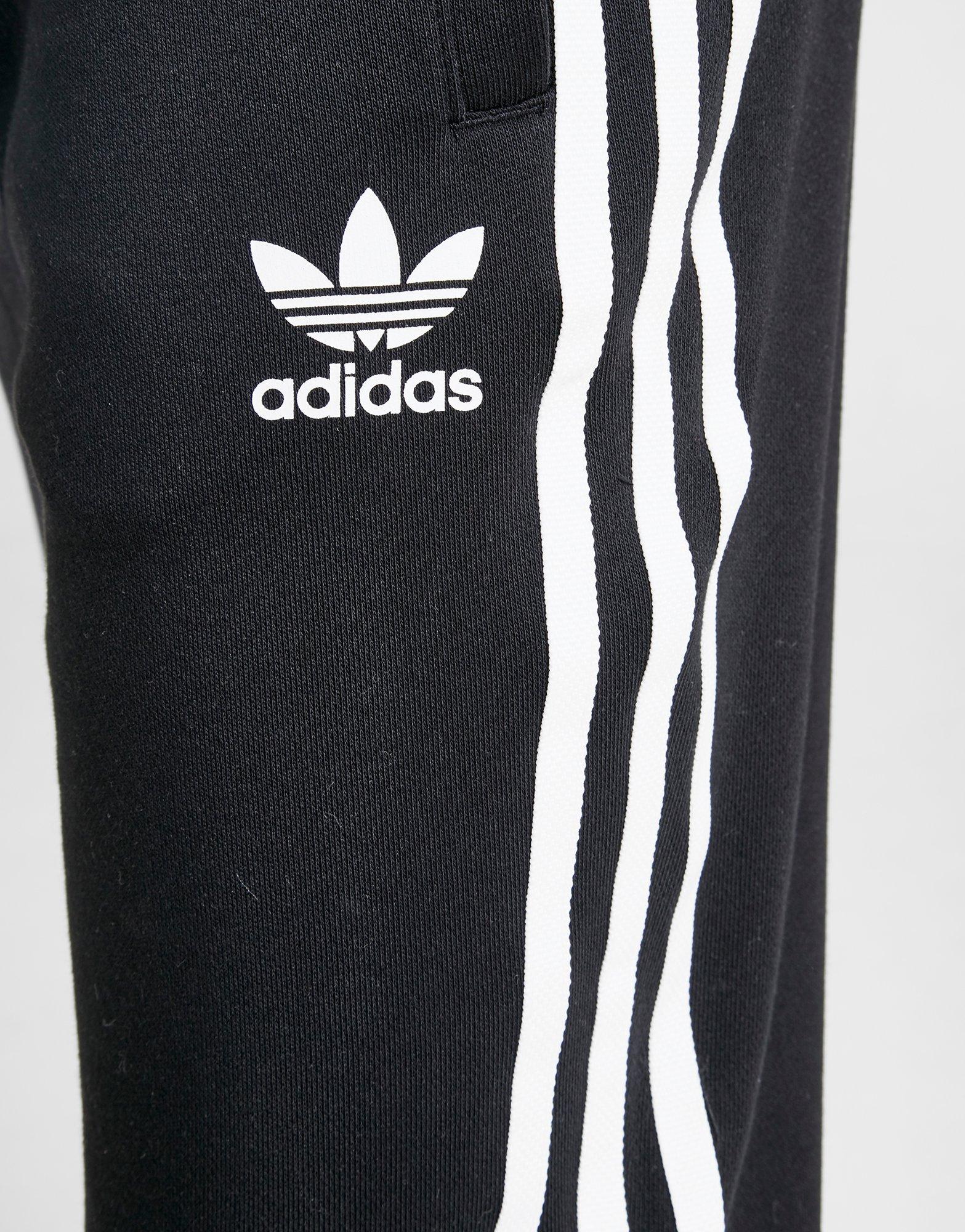 grey adidas joggers with black stripes