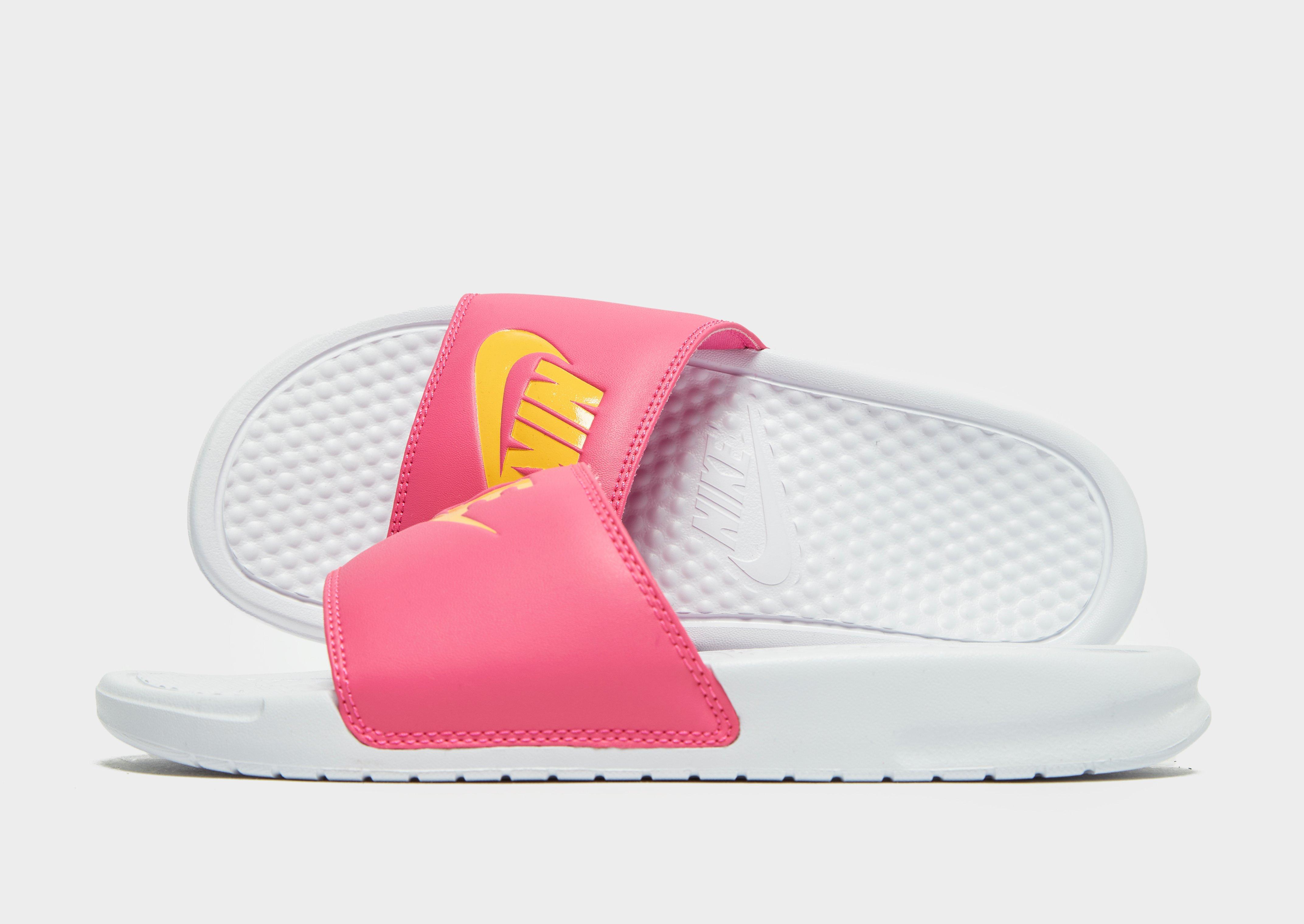 pink and yellow nike slides