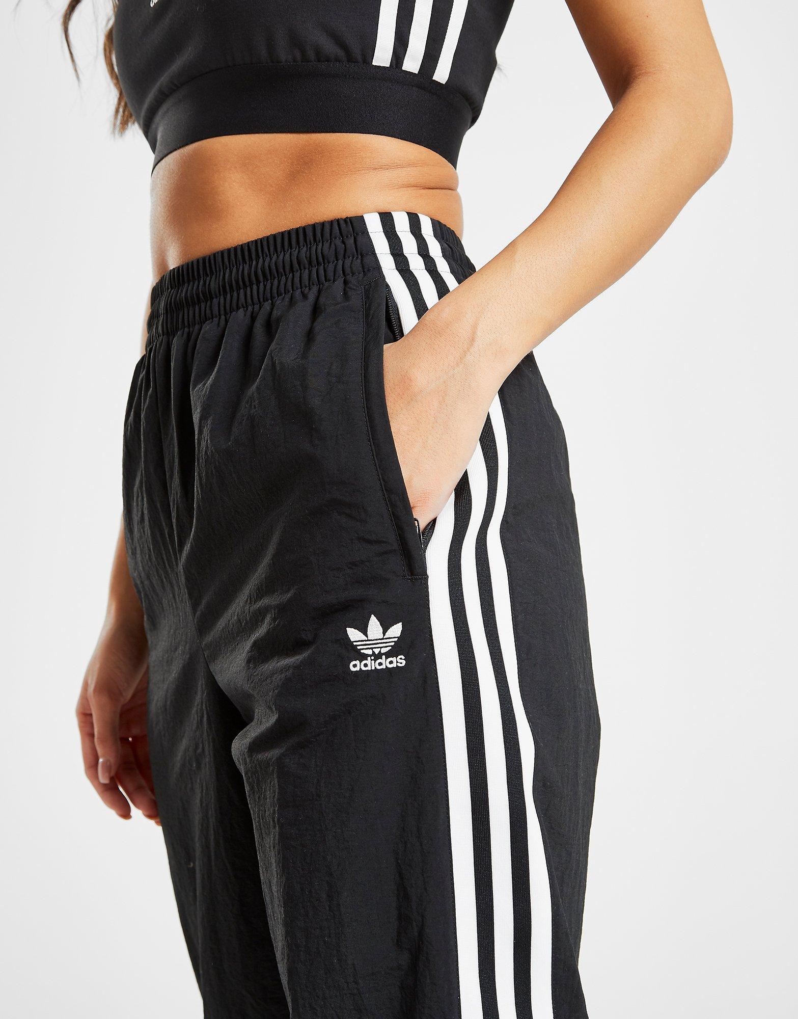 adidas original three stripe track pant with vintage logo in pink