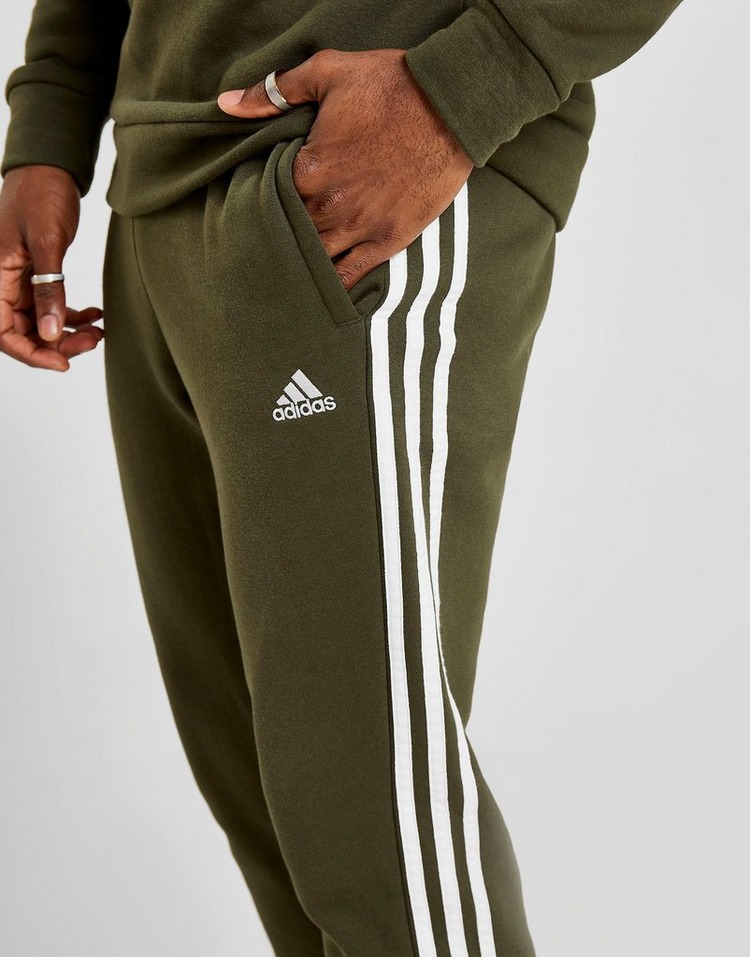 black adidas pants with green stripes