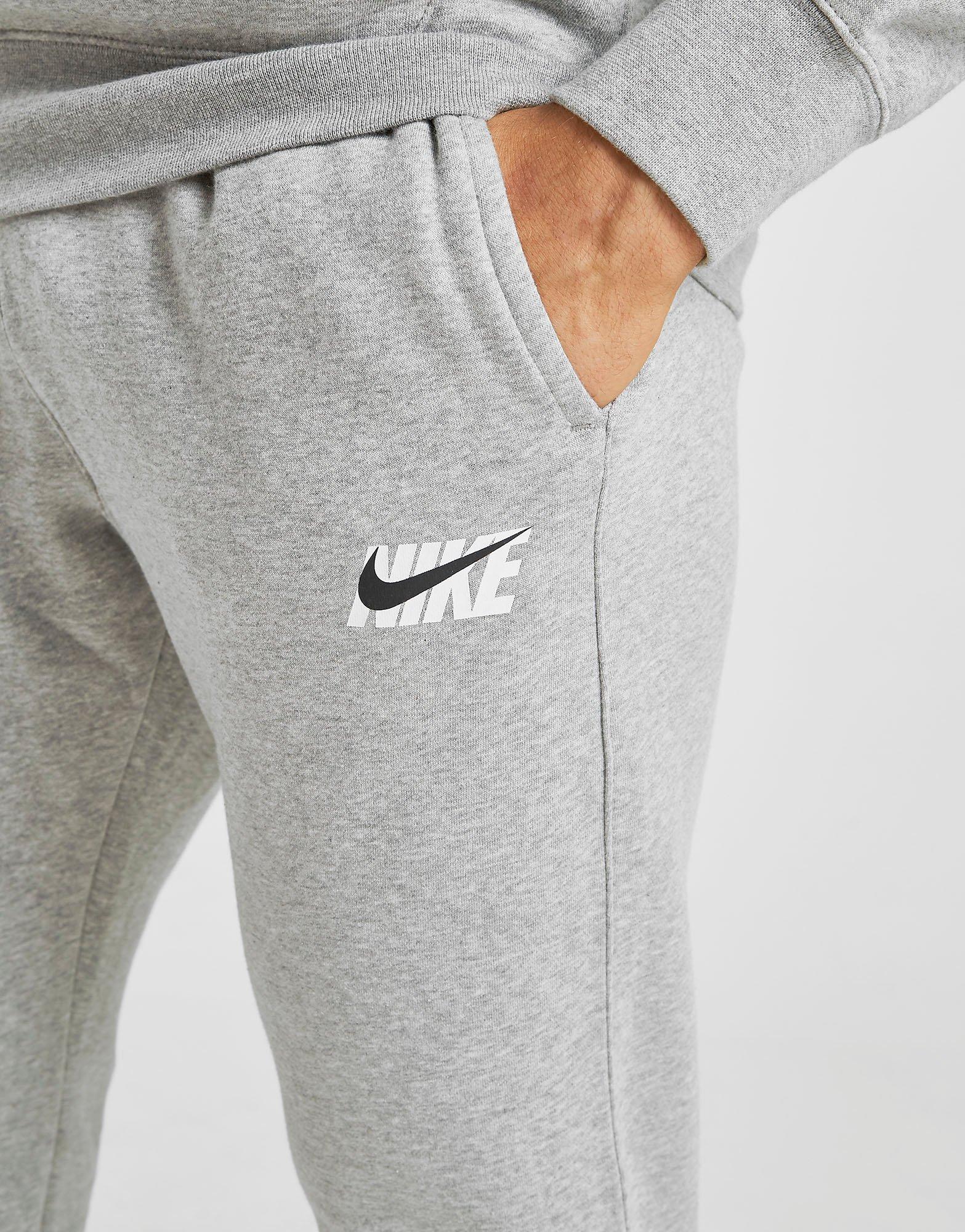 grey nike joggers with black zipper