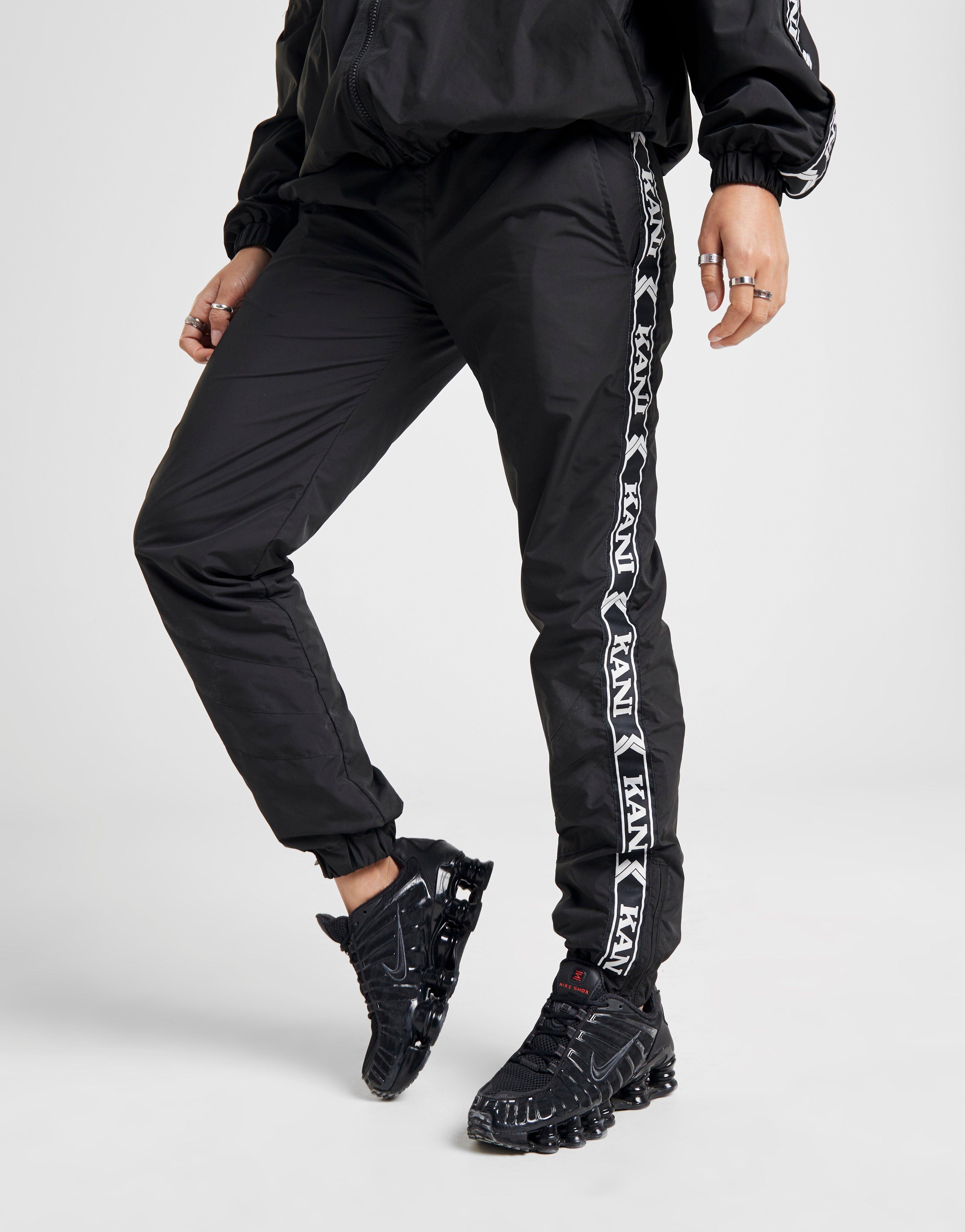 Compra Karl Kani pantalón de chándal Woven Tape en Negro