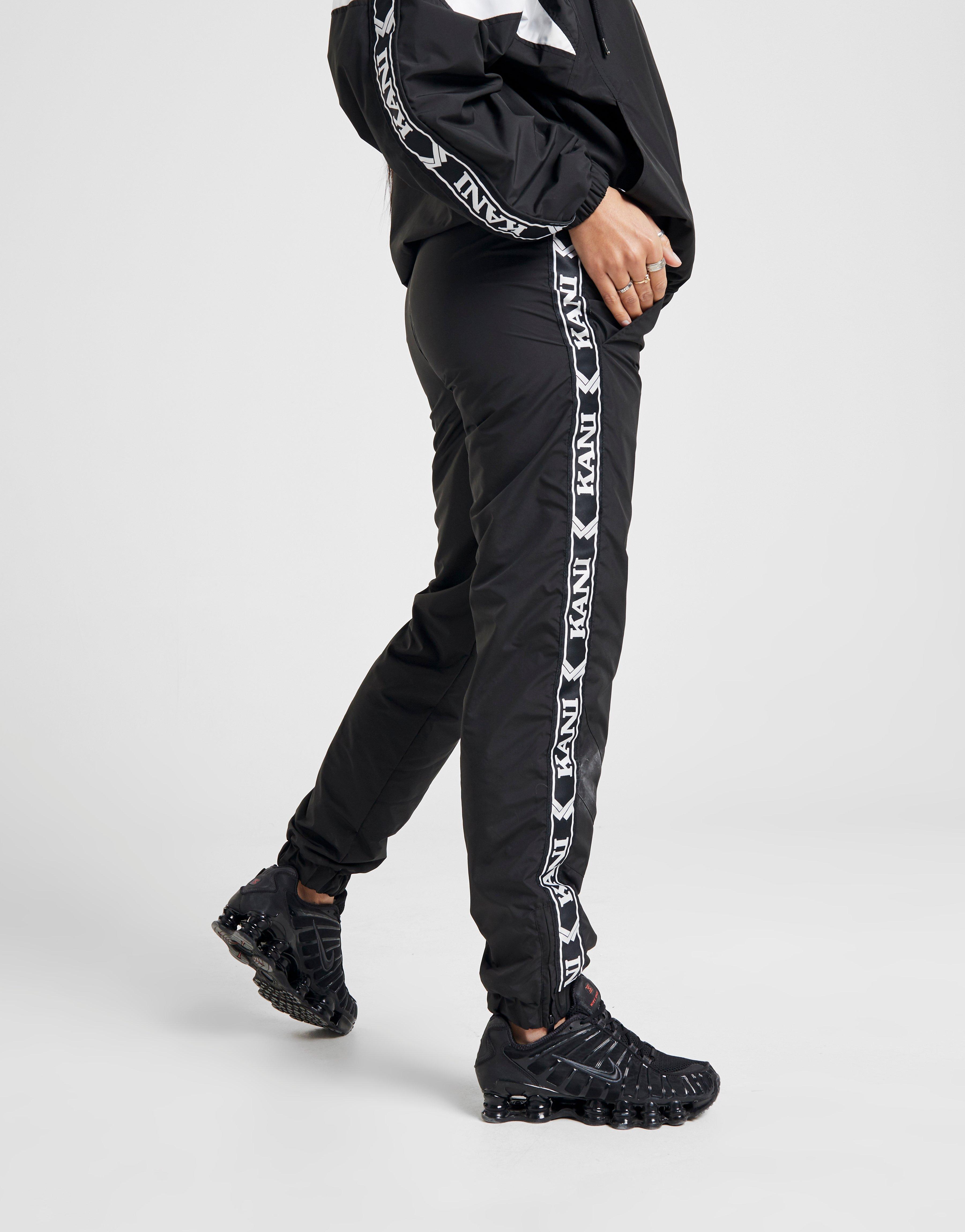 Compra Karl Kani pantalón de chándal Woven Tape en Negro