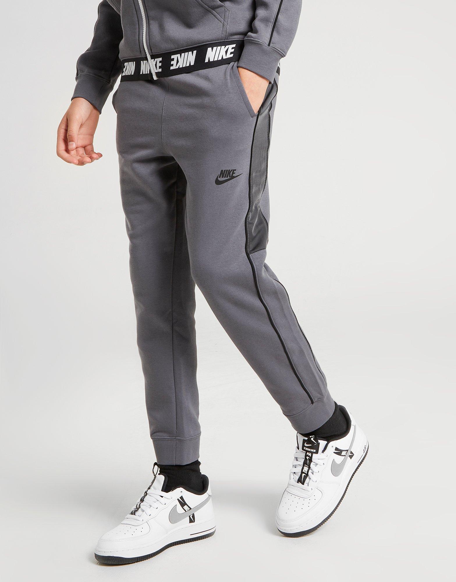 grey nike joggers with black stripe