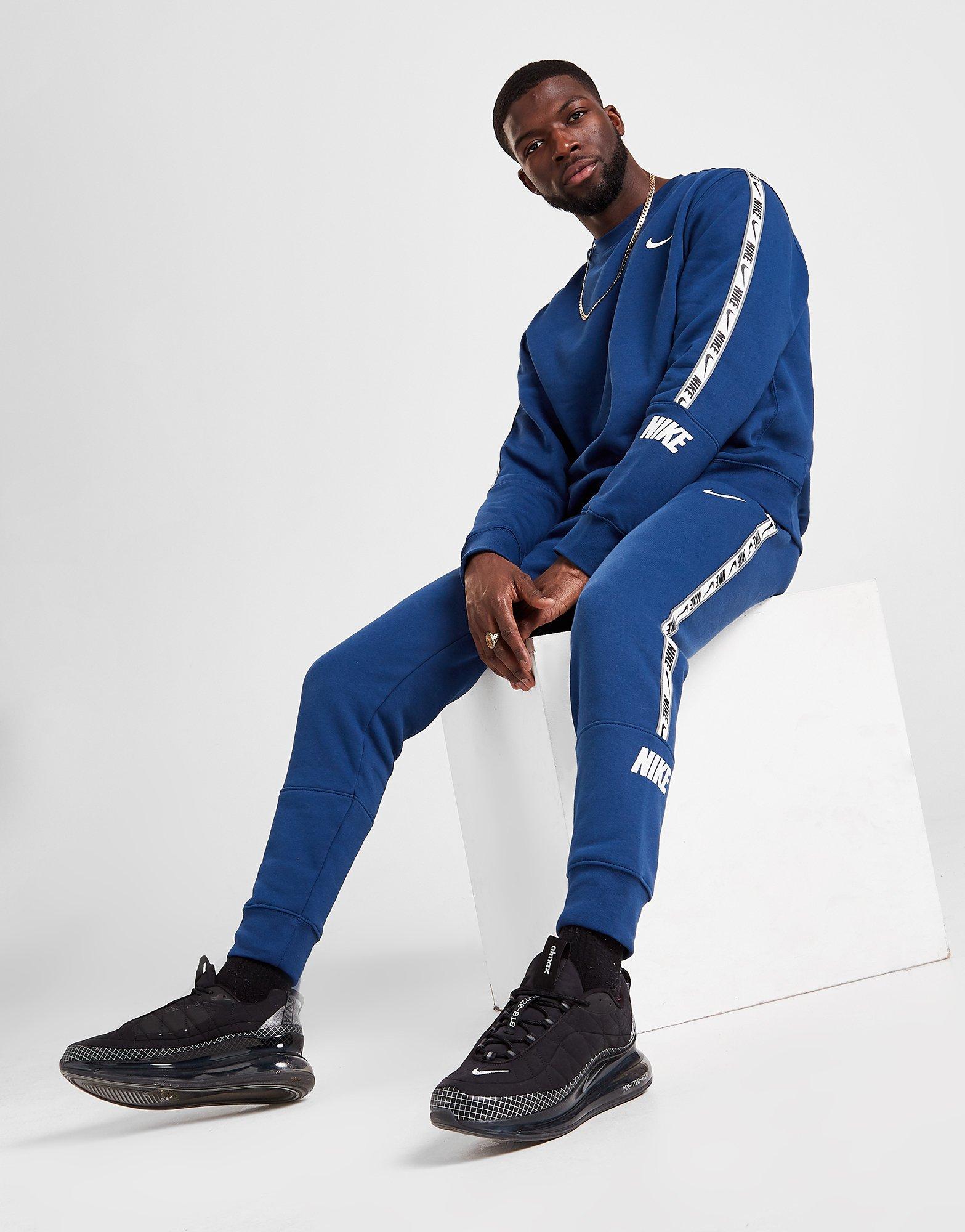 nike tape track pants blue