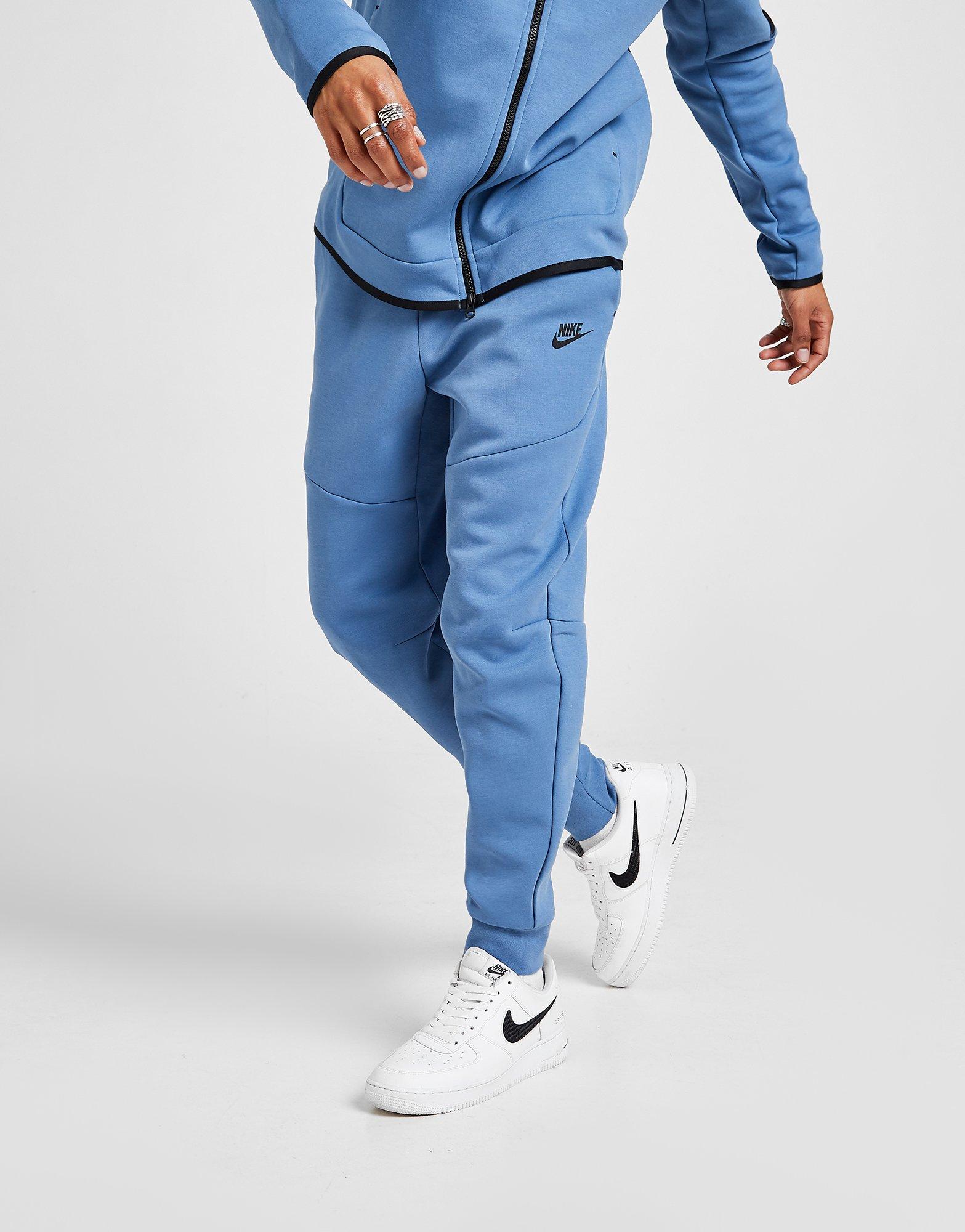 blue and black nike tech tracksuit
