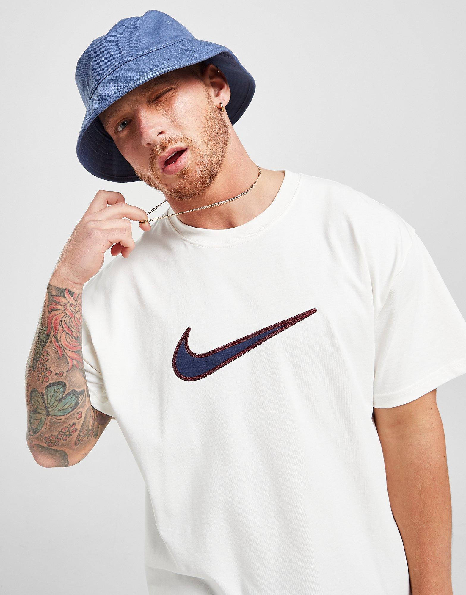 white nike shirt with blue swoosh