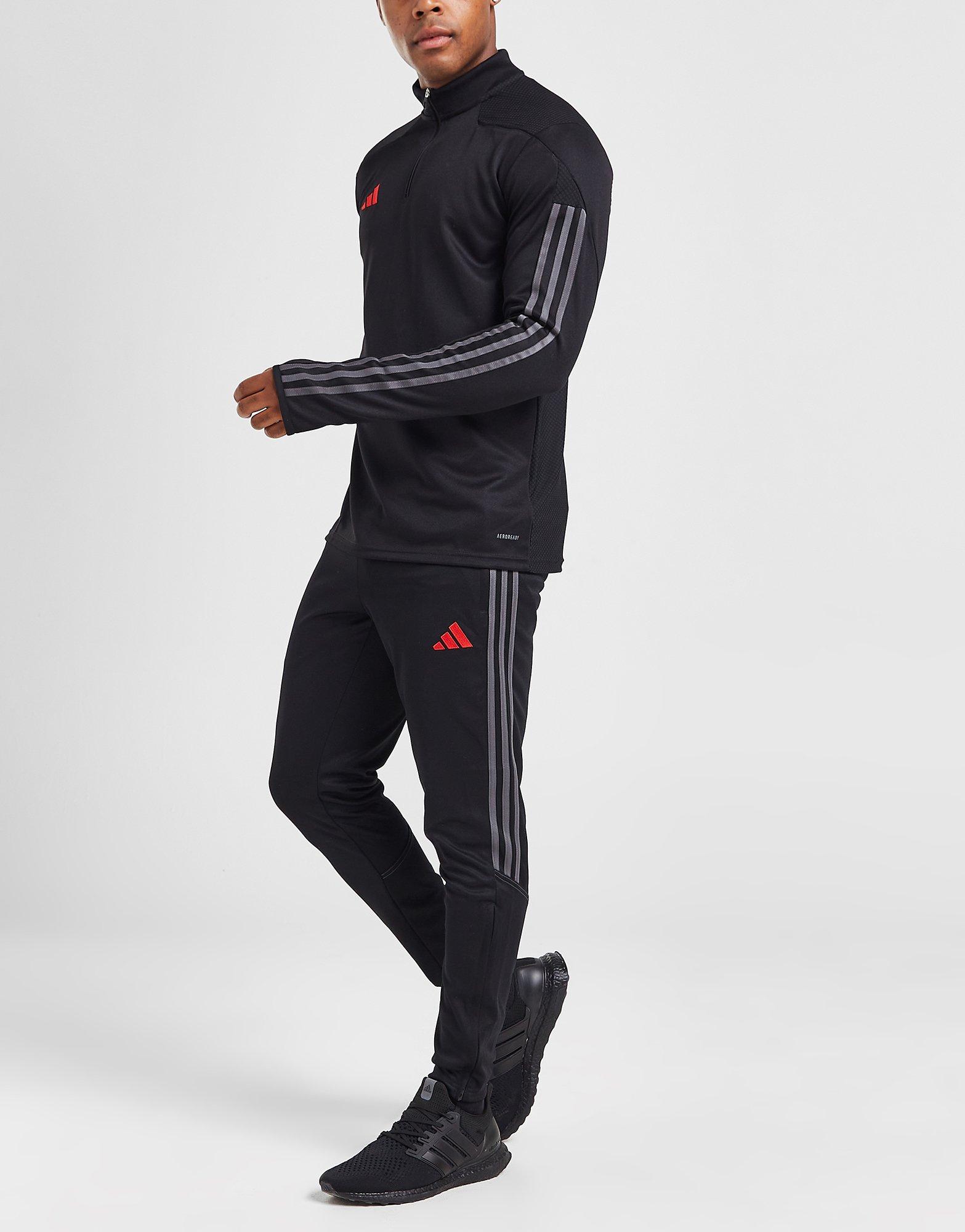 Le pantalon survêtement accent filet Tiro noir, Adidas