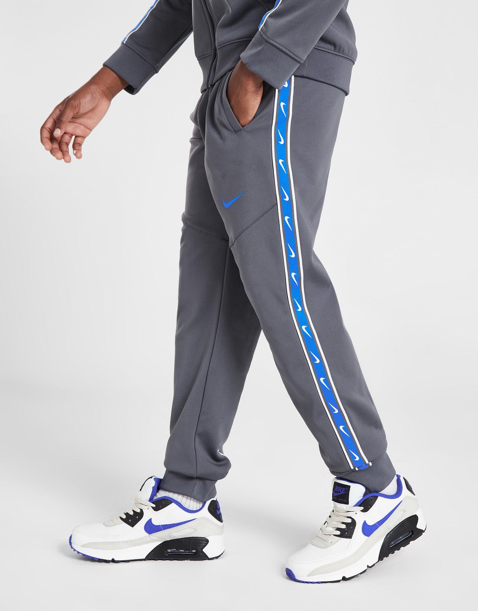 Nike sportswear taped track pant hotsell