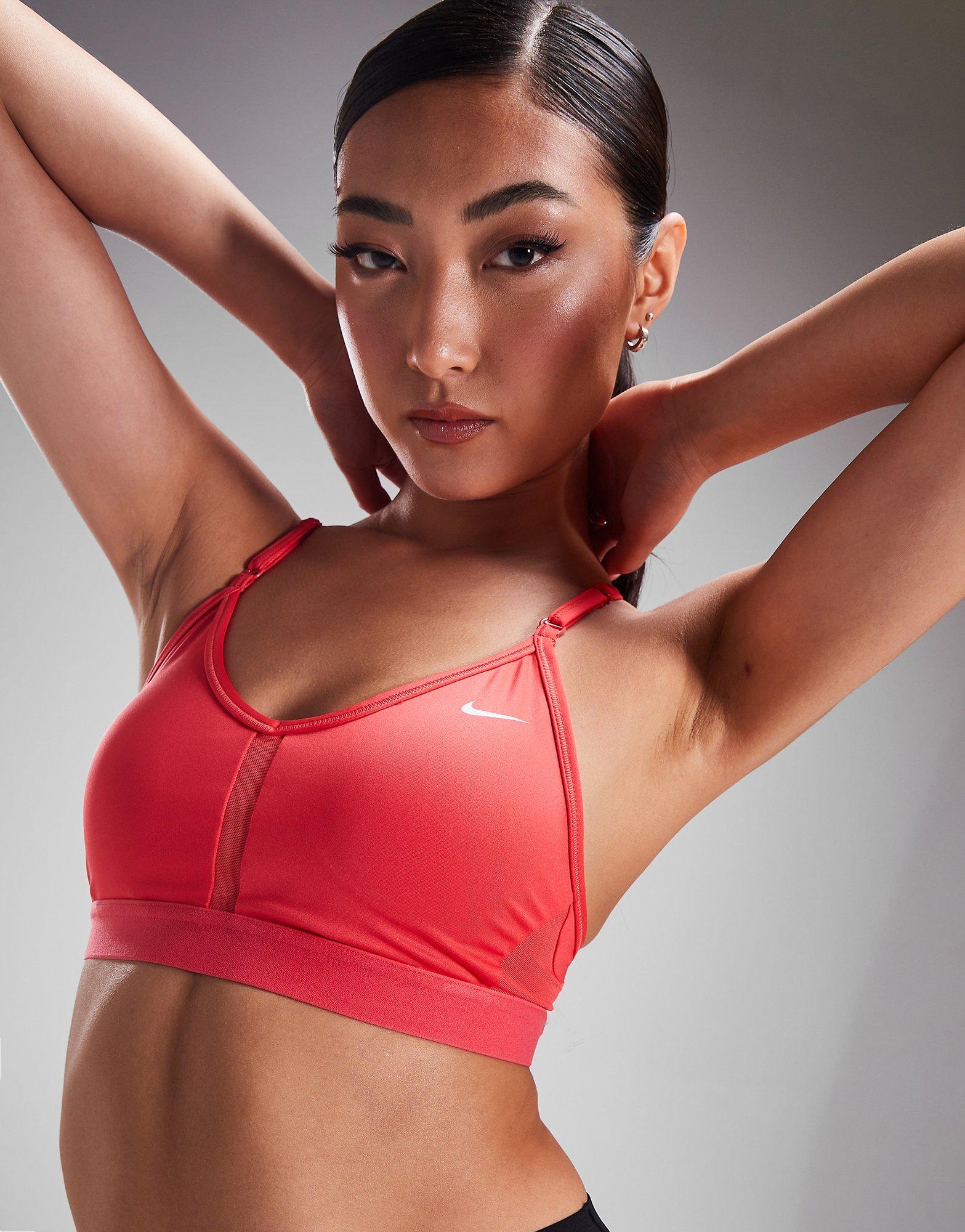 Nike Training Indy light support logo metallic sports bra in burgundy and  pink