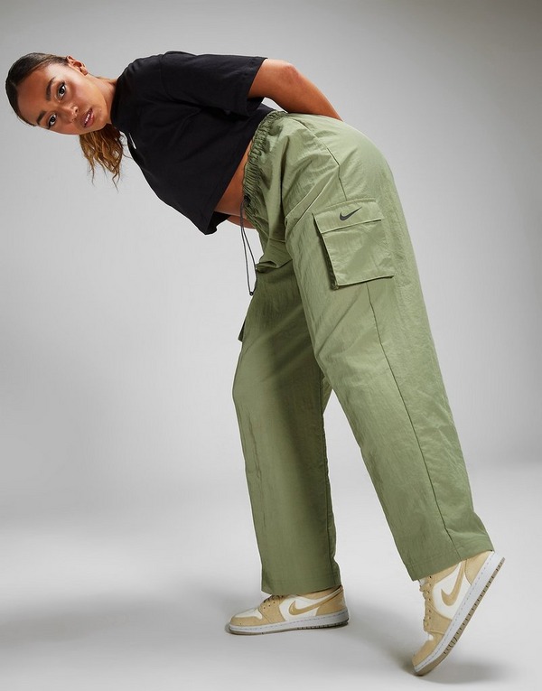 Premium Photo  A woman in a white top and cargo pants stands in