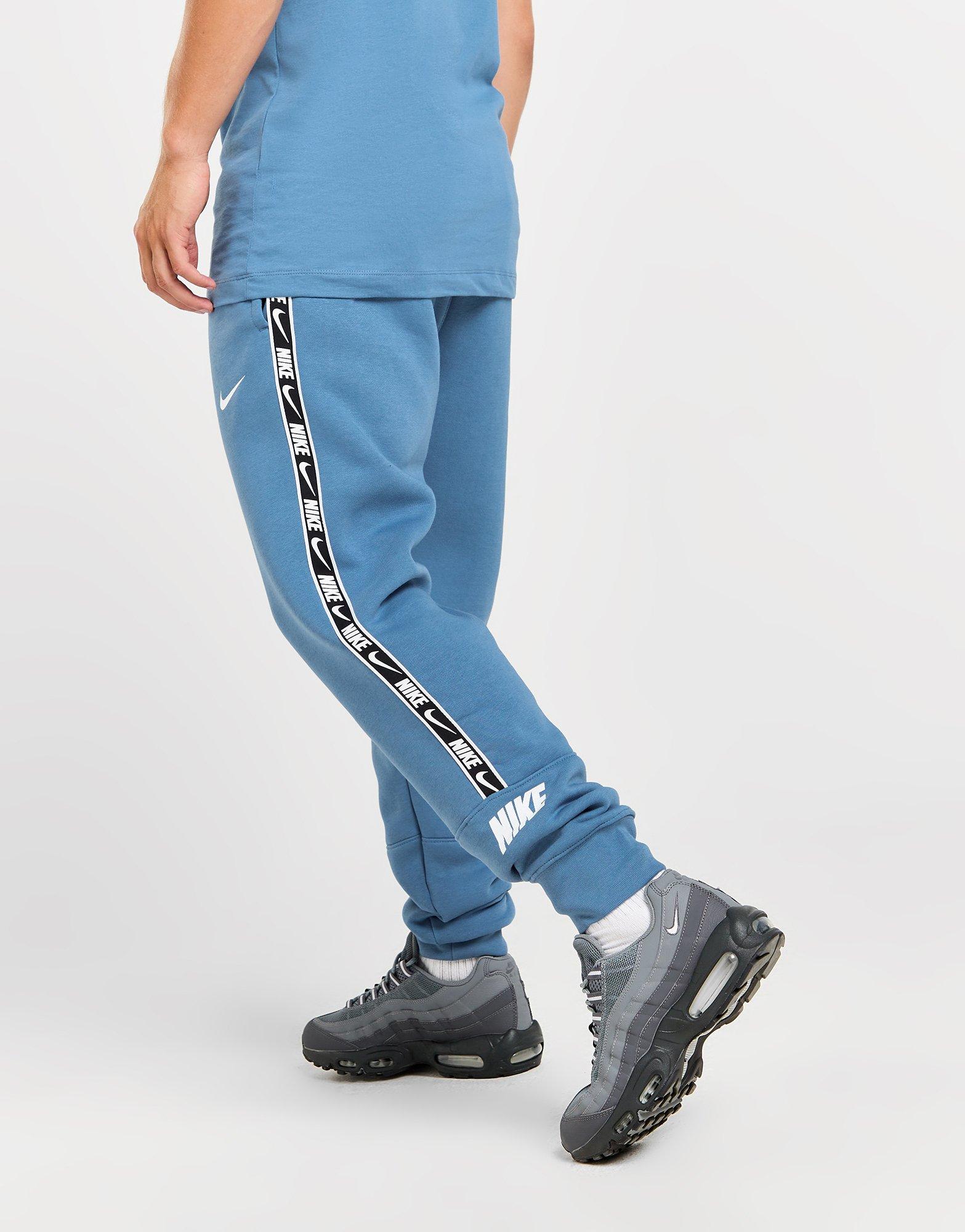 Nike swoosh taped joggers sale