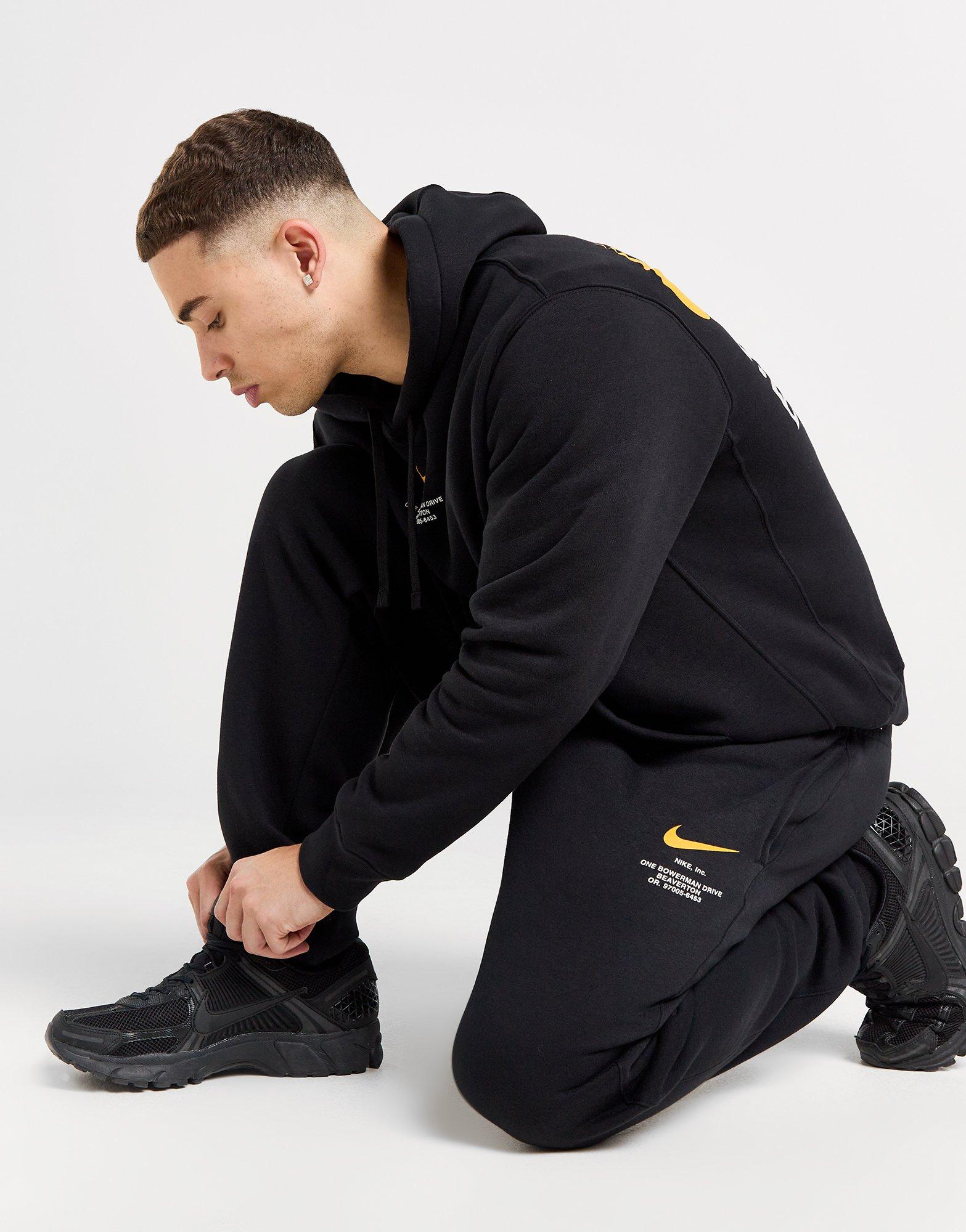 Nike swoosh track pants black sale