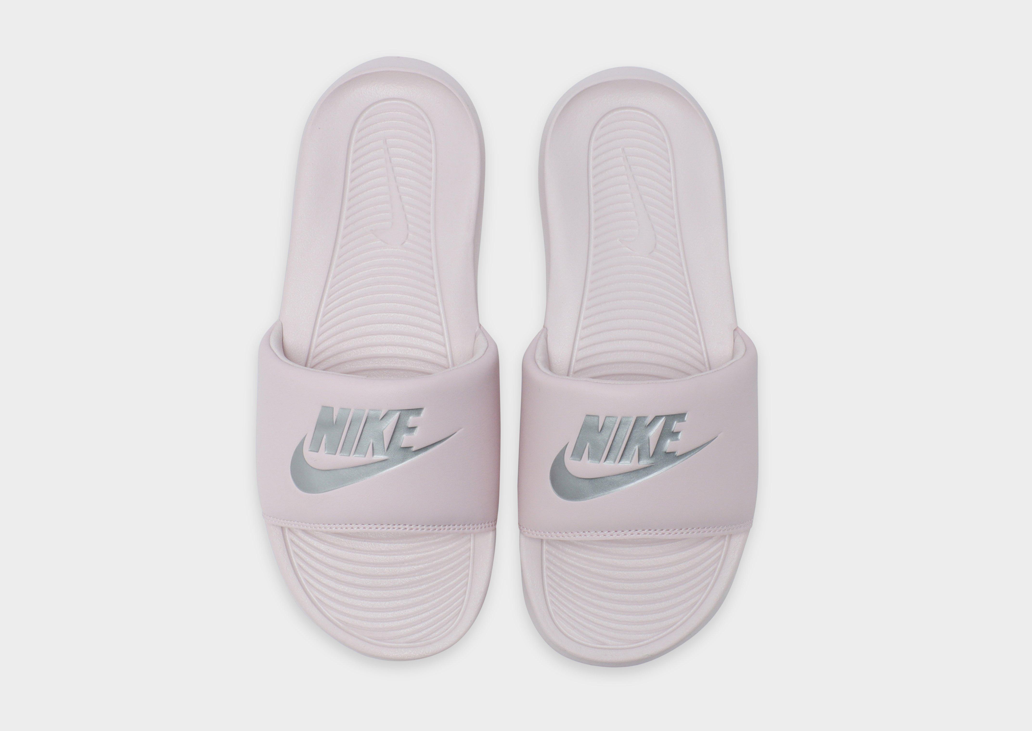 Pink and store black nike slides