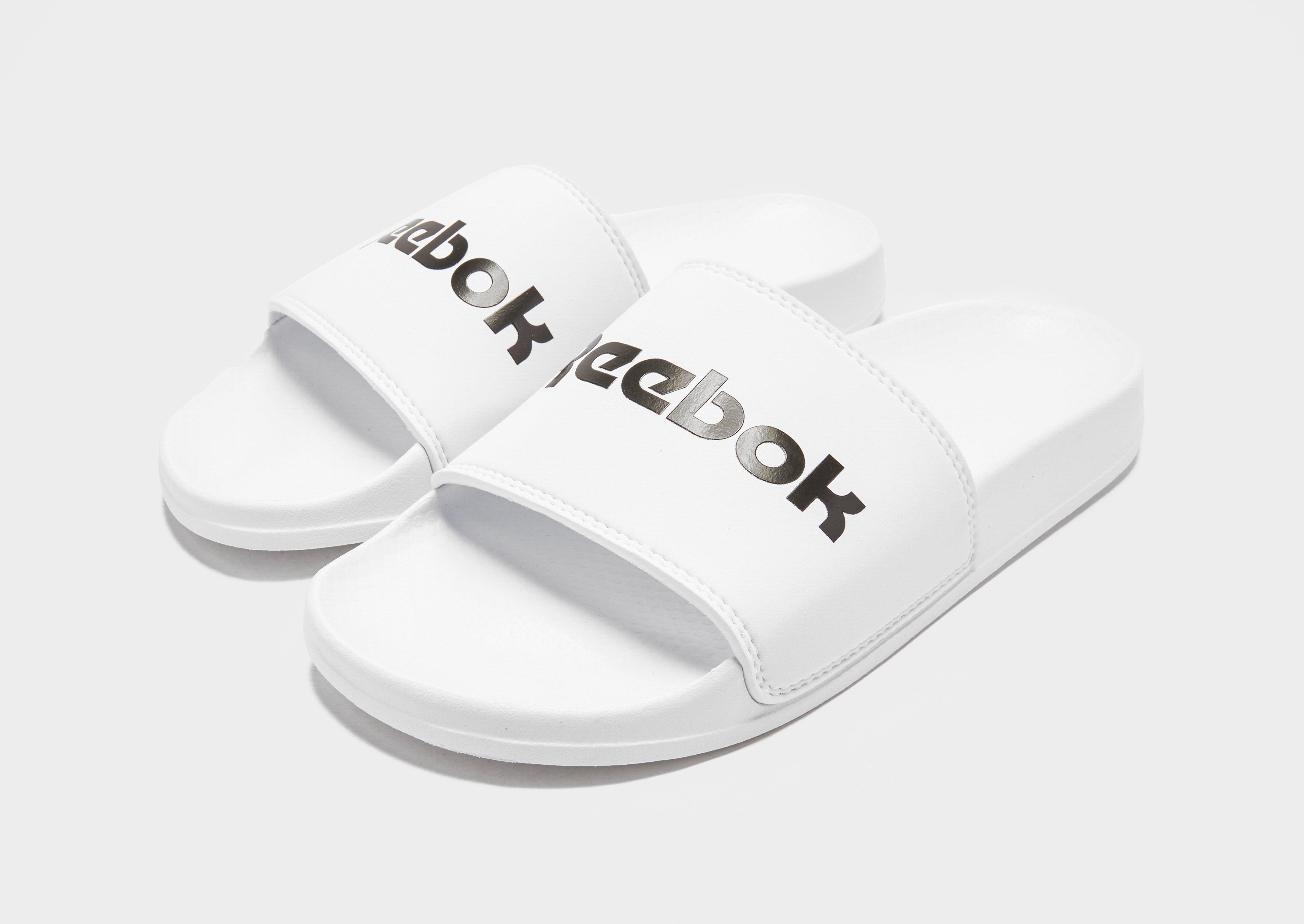 white reebok slides