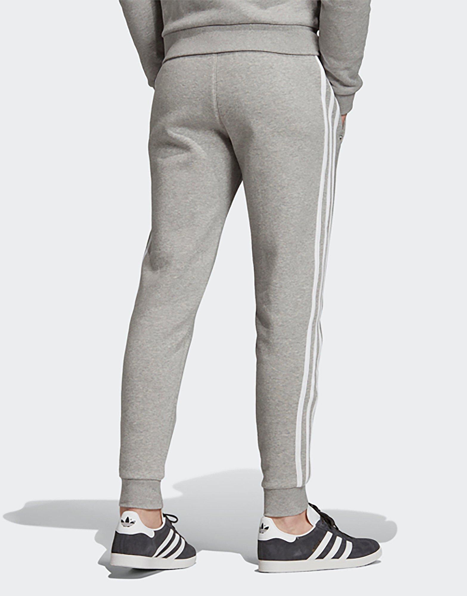 grey adidas joggers with black stripes