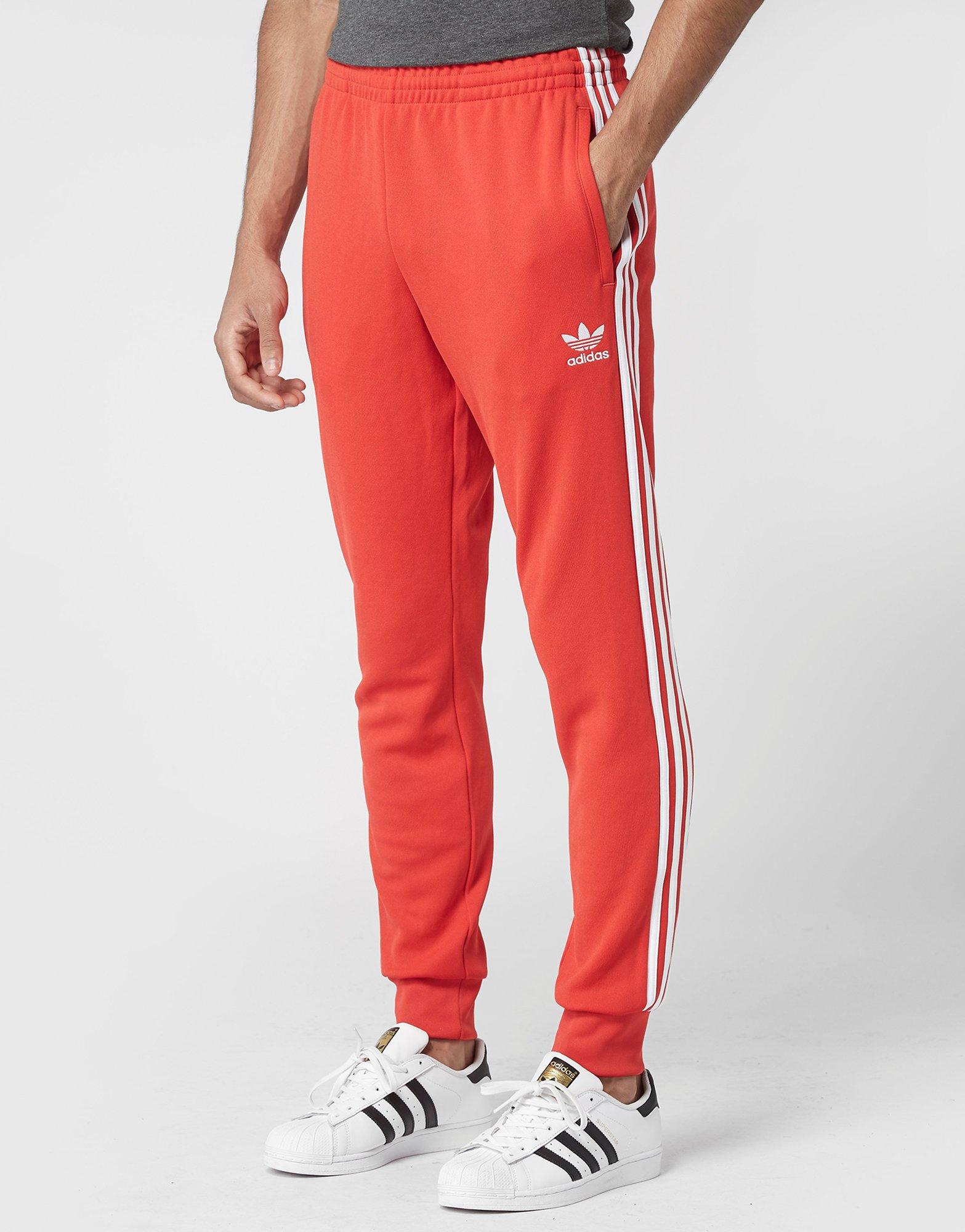 red adidas cuffed track pants