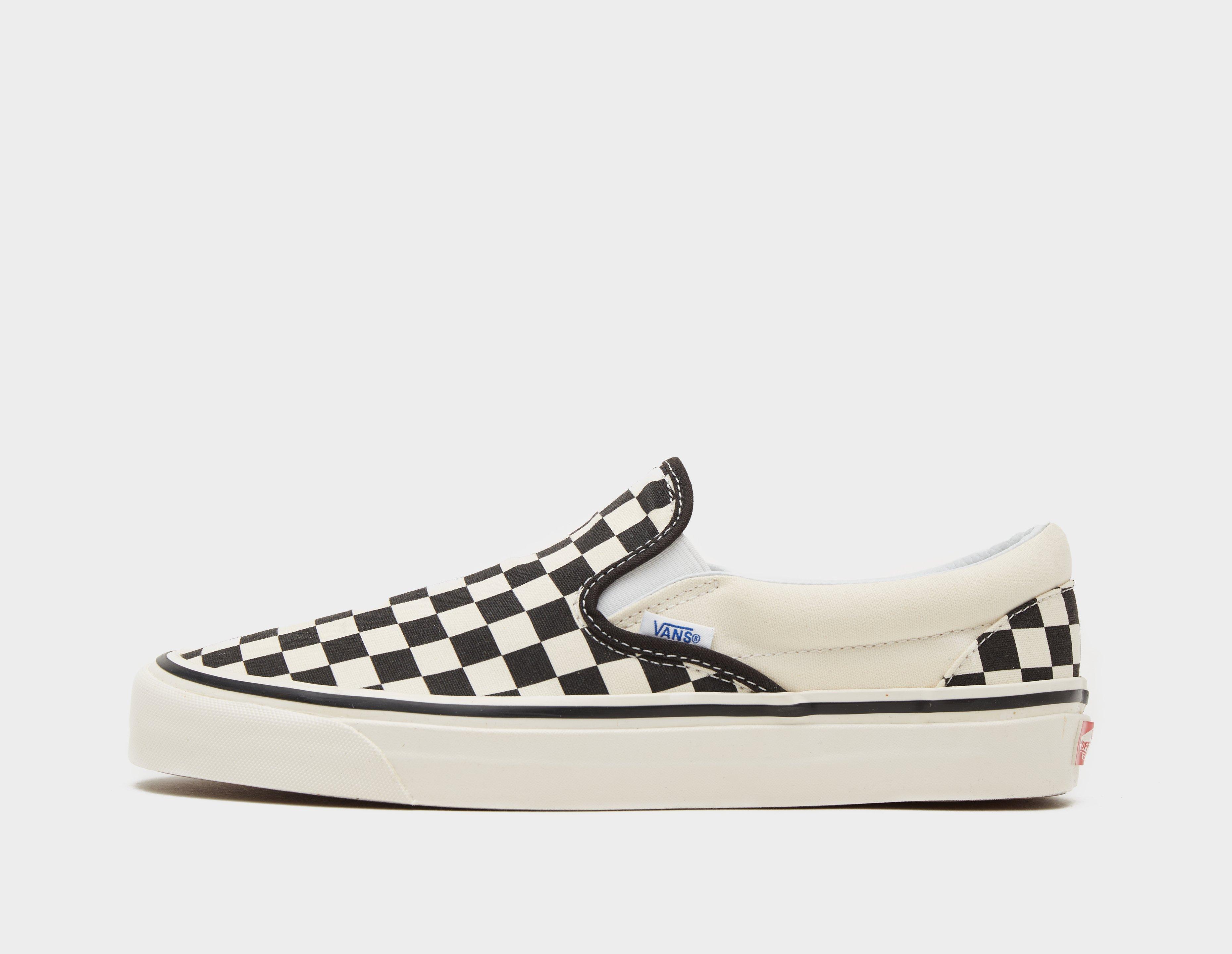 Black and white checkerboard slip hot sale on vans