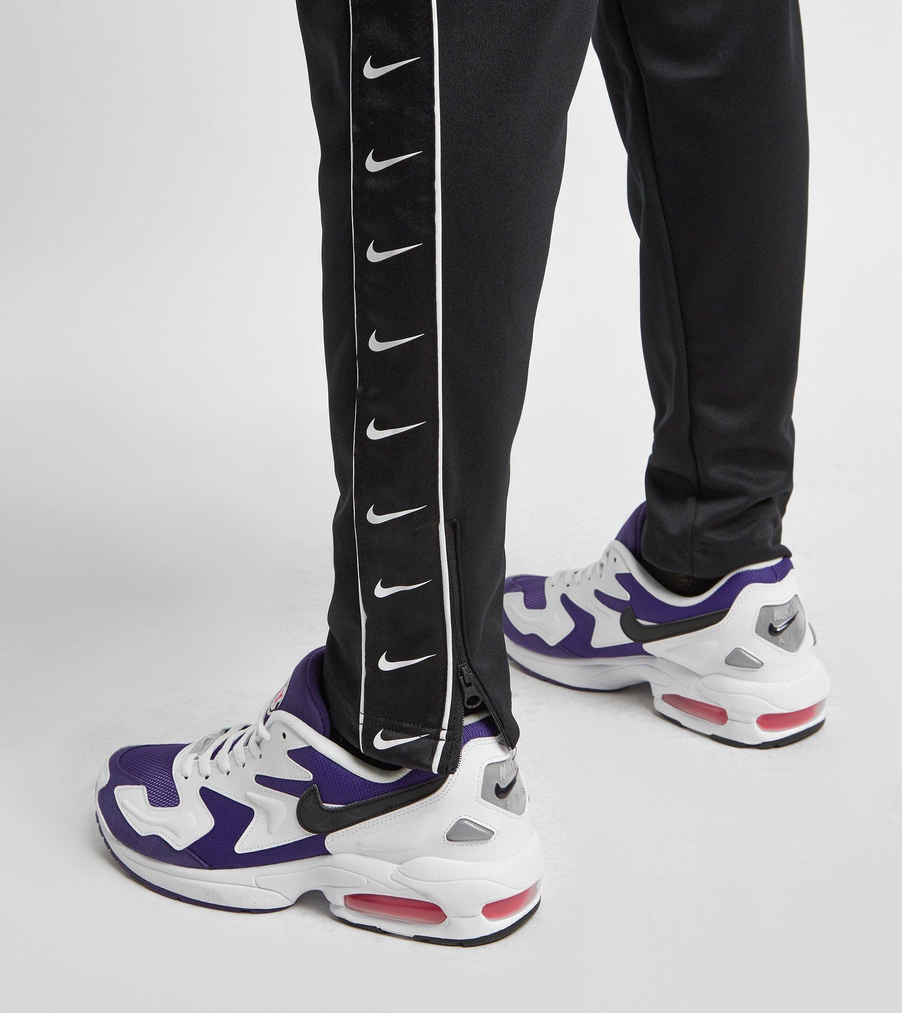 nike swoosh tape track pants