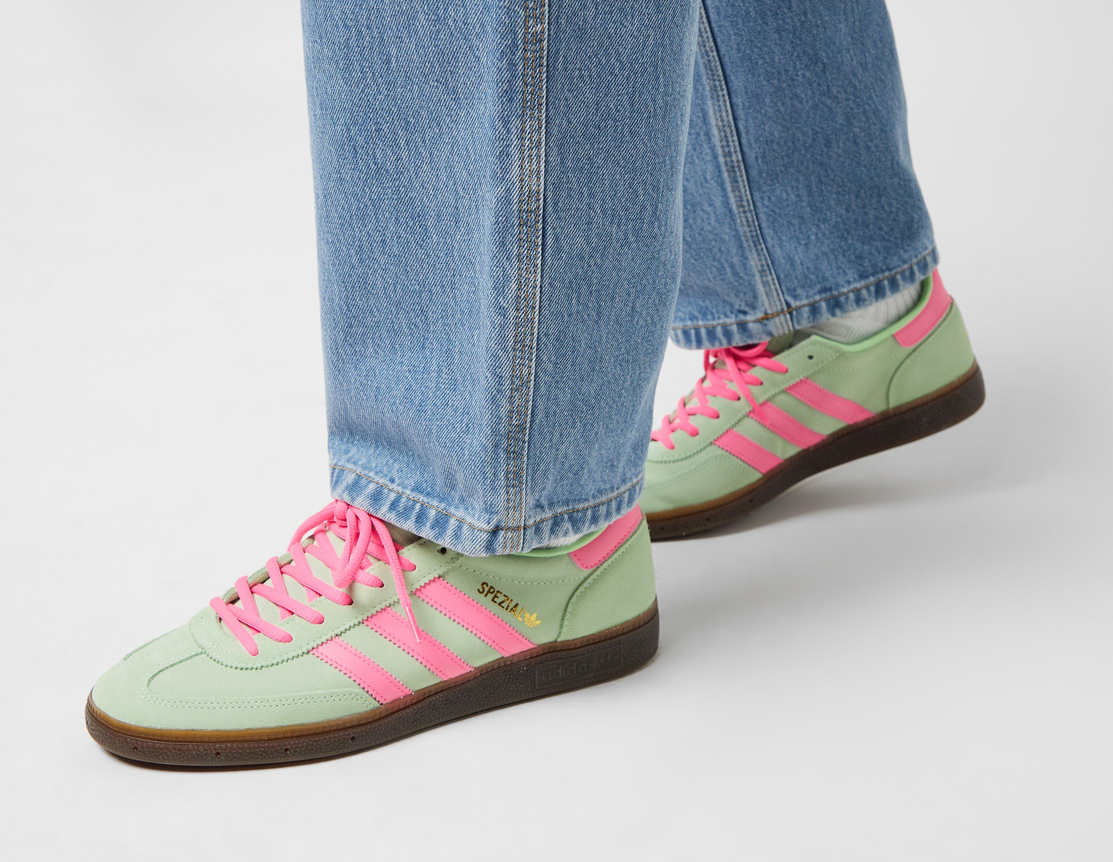 This is a sneaker in green, pink and with a dark gum sole.