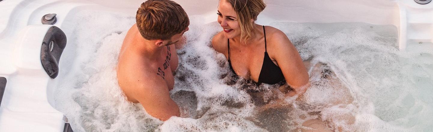 Two people enjoying themselves in a hot tub