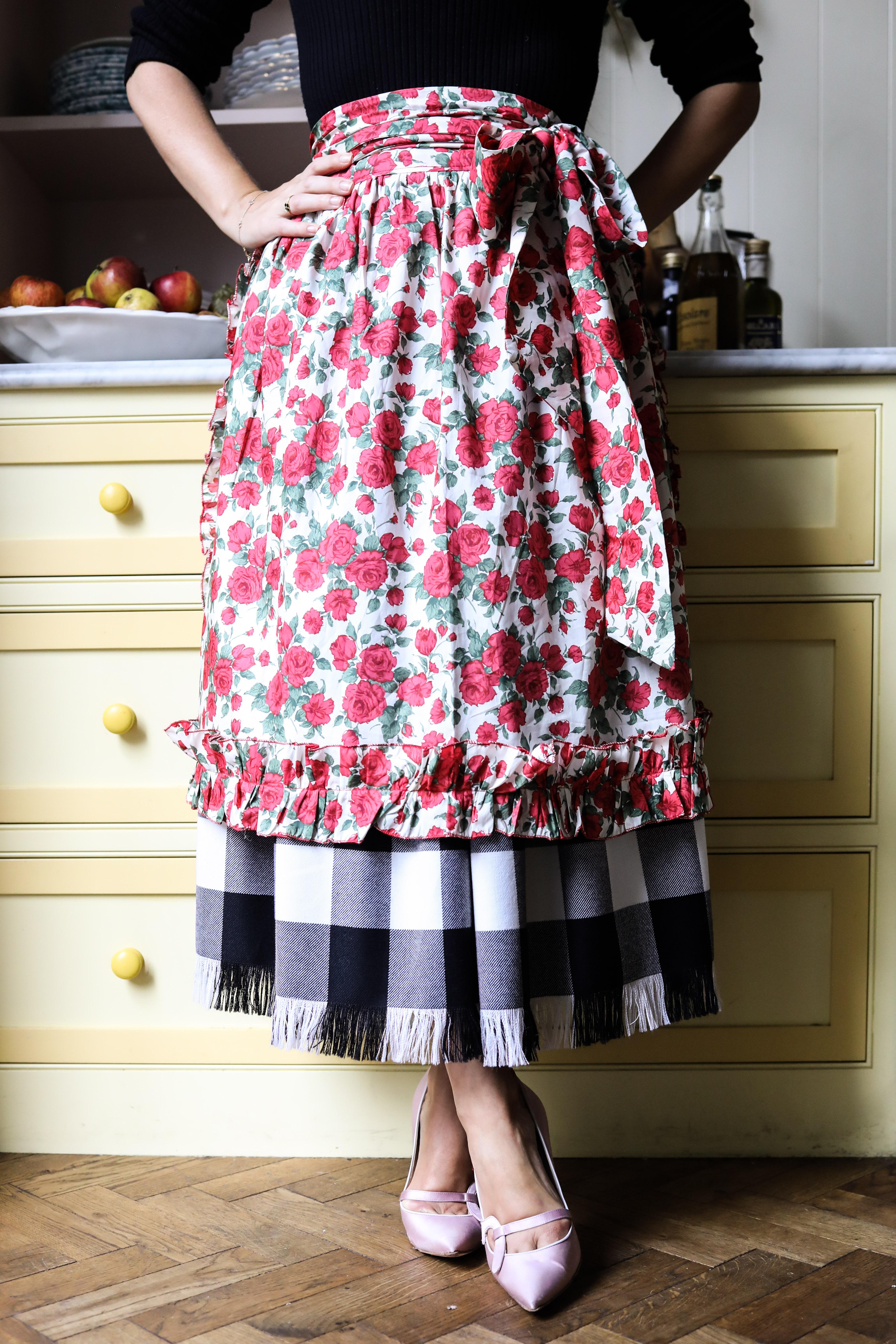 coco and wolf apron on model in kitchen