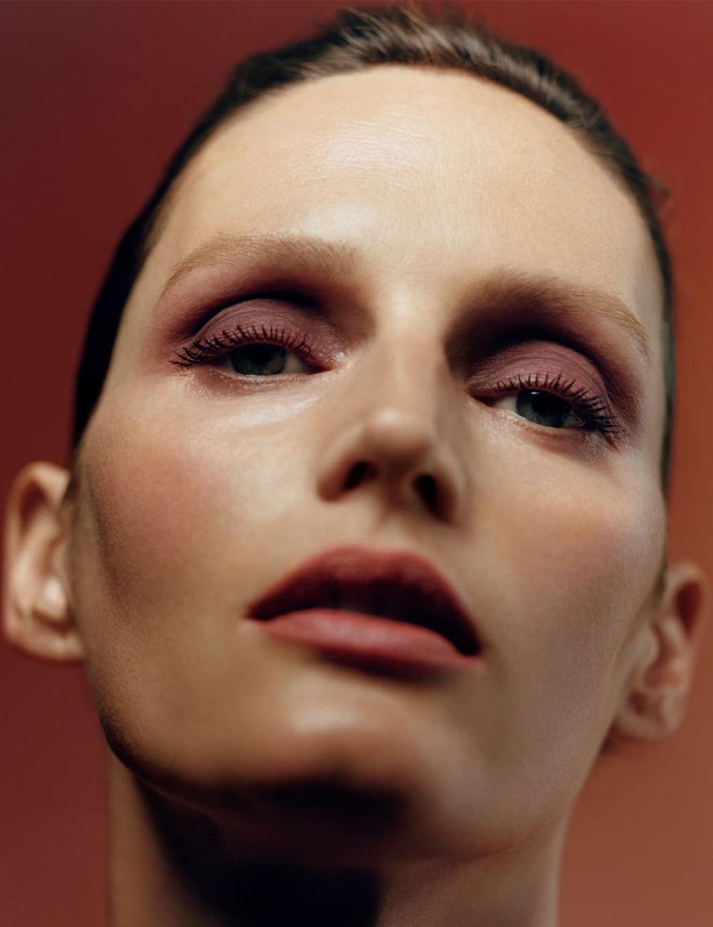 Model wearing terracotta red makeup look by Byredo