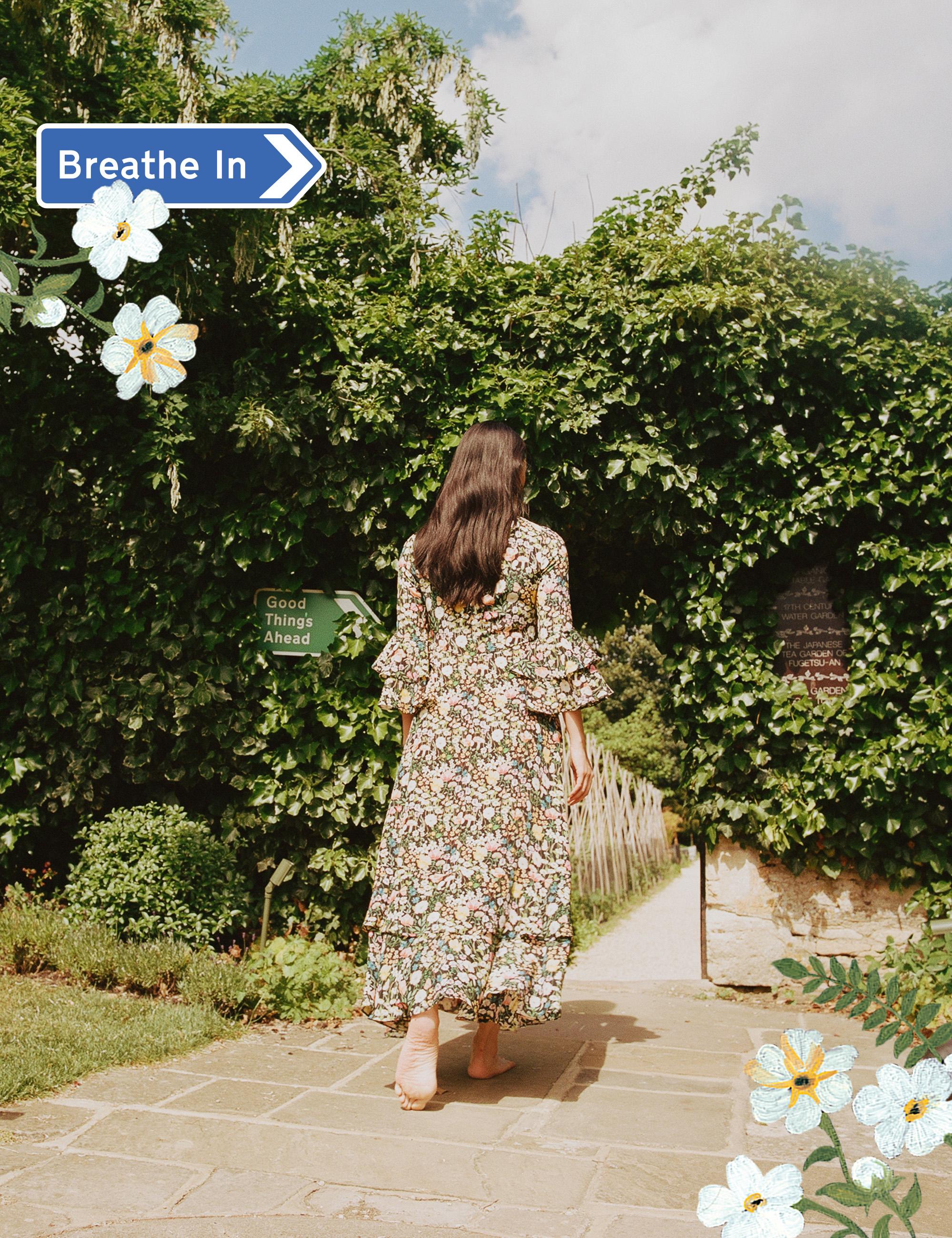 women in Liberty dress walking in garden
