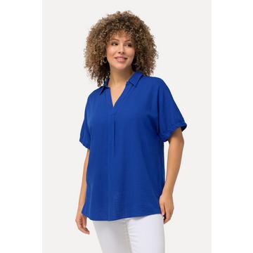 Blouse oversize en lin mélangé. Décolleté en V et manches courtes.