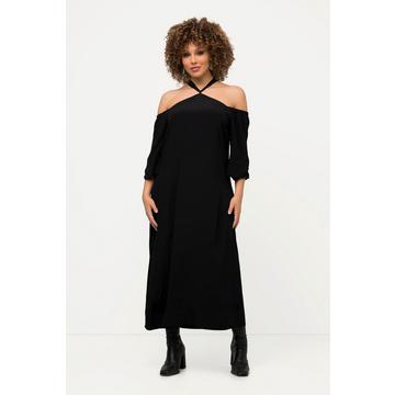 Robe midi à manches longues. Silhouette en A. Fermeture sur la nuque et fente sur le côté.