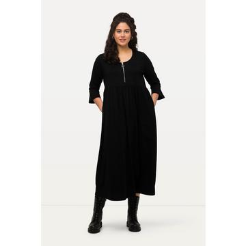 Robe en jersey à col rond et manches 3/4. Couture empire et ligne en A.