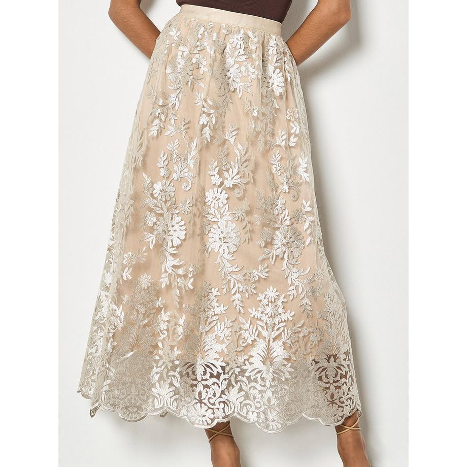 Jupe mi-longue en maille chatoyante avec broderies florales