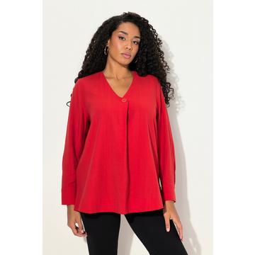 Blouse manches longues, matière texturée, bouton fantaisie au bas du décolleté en V