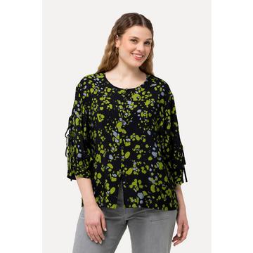 Blouse imprimé à pois. Col rond et manches longues. Silhouette en A.