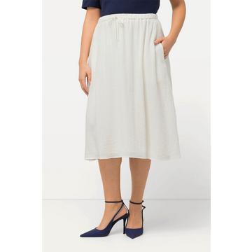 Jupe midi avec coutures fantaisie et taille élastique. Ligne en A.