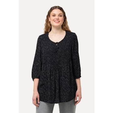 Blouse smockée à pois, avec décolleté rond et manches 3/4. Silhouette en A.