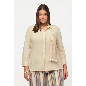 Chemisier en coton bio texturé. Col chemise et manches longues.