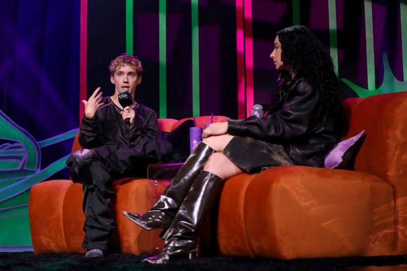 Photo of Troye Sivan (L) and Charli XCX (R) speaking at the 2024 GRAMMY U Fall Summit