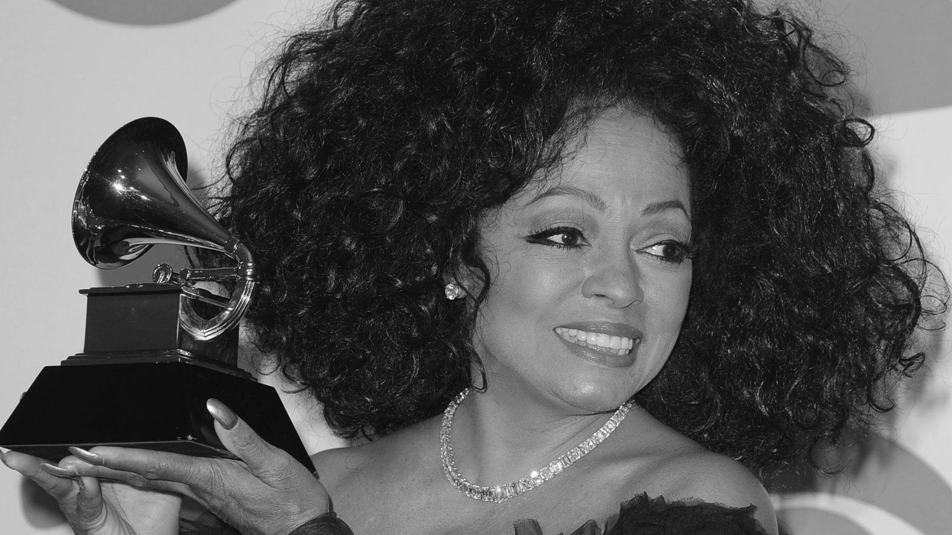 Diana Ross smiles while holding GRAMMY award