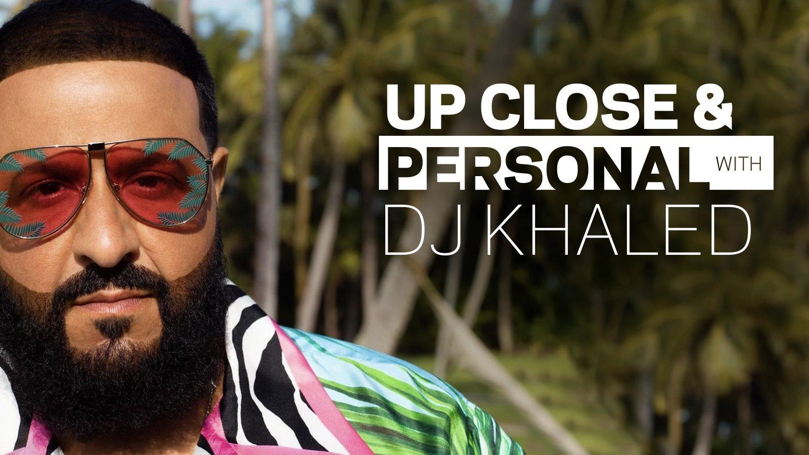 DJ Khaled poses in front of palm trees wearing colorful shirt & shades from his Dolce & Gabbana collab