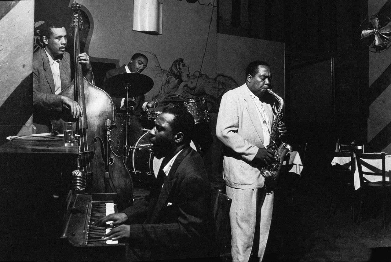 Bassist Charles Mingus (1922 - 1979), drummer Roy Haynes, pianist Thelonious Monk (1917 - 1982) and saxophonist Charlie Parker (1920 - 1955) perform at the Open Door, New York, New York, September 13, 1953.