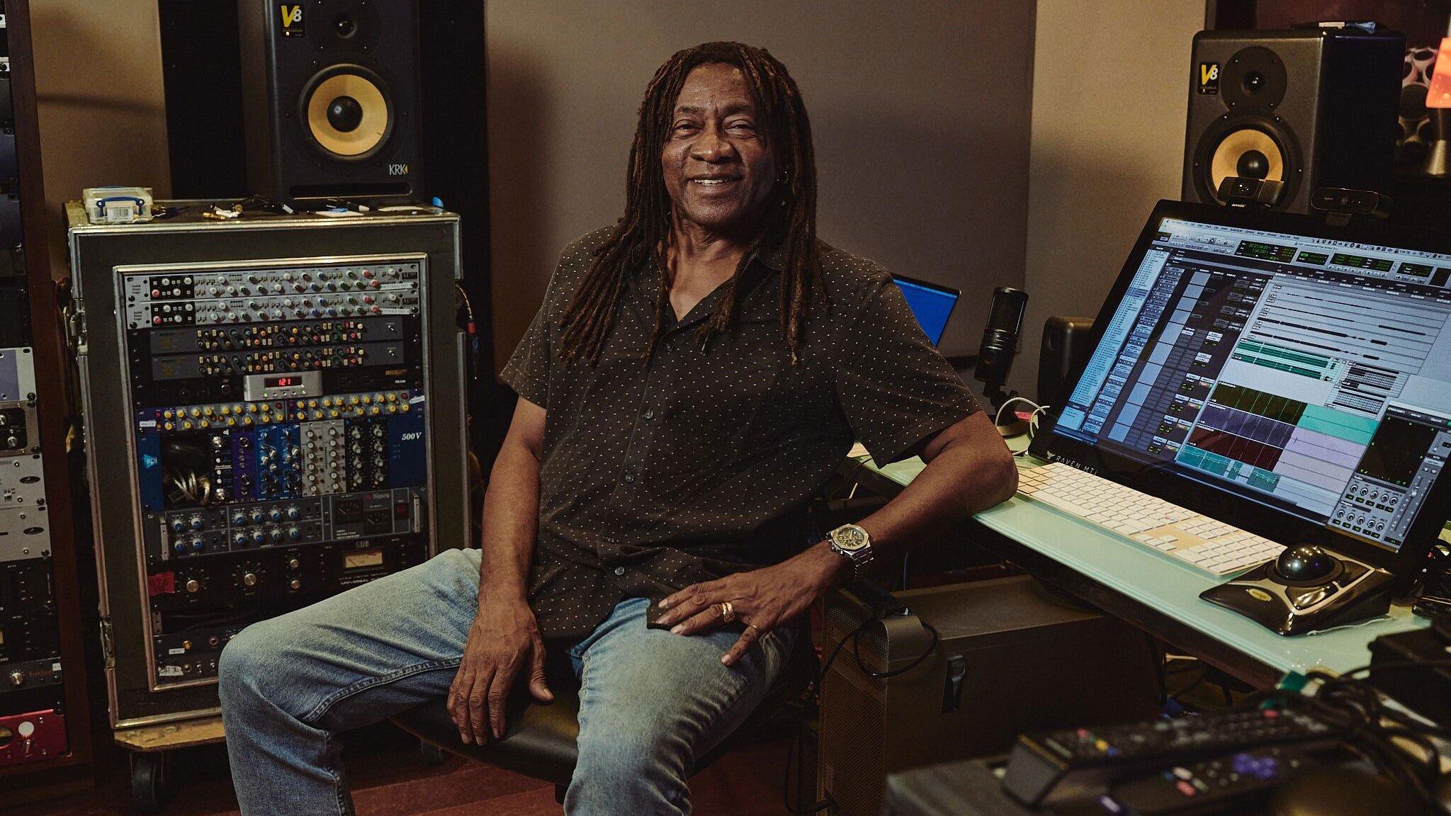 Photo of producer, engineer, mixer, and five-time GRAMMY winner Jimmy Douglass in his studio surrounded by production gear.