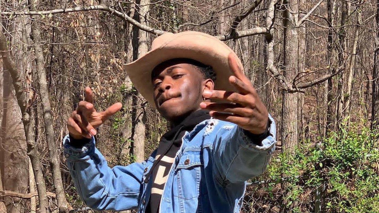 Lil Nas X posing with cowboy hat on