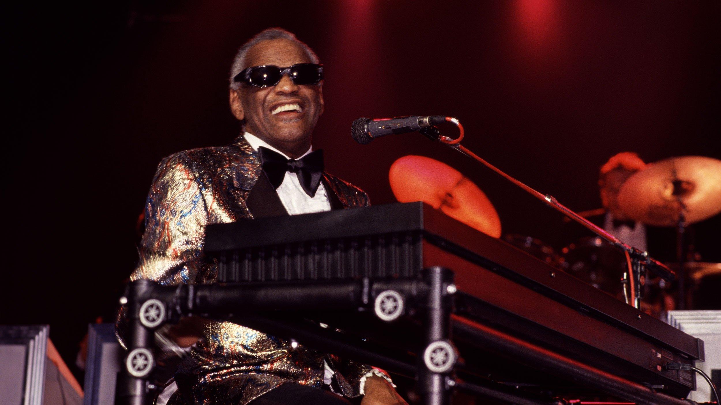 Ray Charles plays piano as he performs onstage in Portugal in 1988.