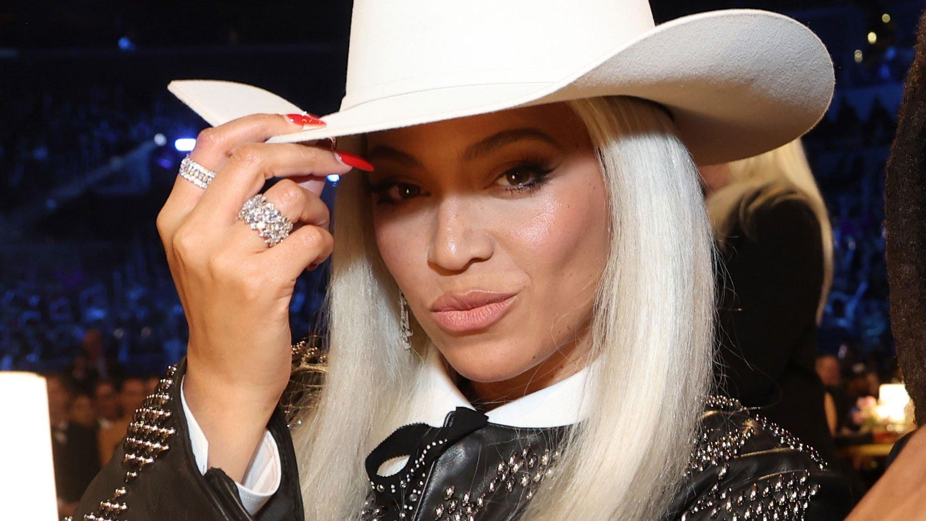 Beyonce tips her white cowboy hat to the camera at the 2024 GRAMMYs