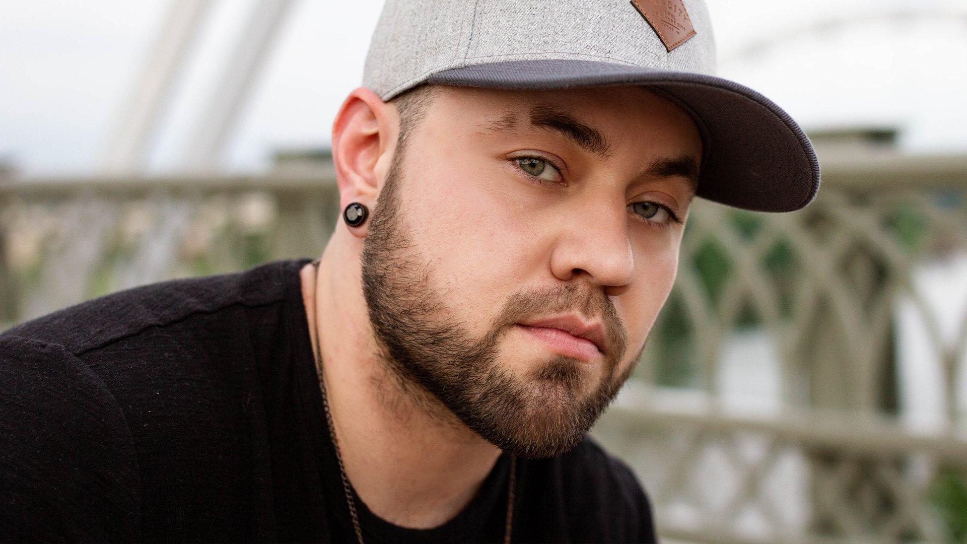Closeup photo of singer/songwriter Brody Ray wearing a baseball cap
