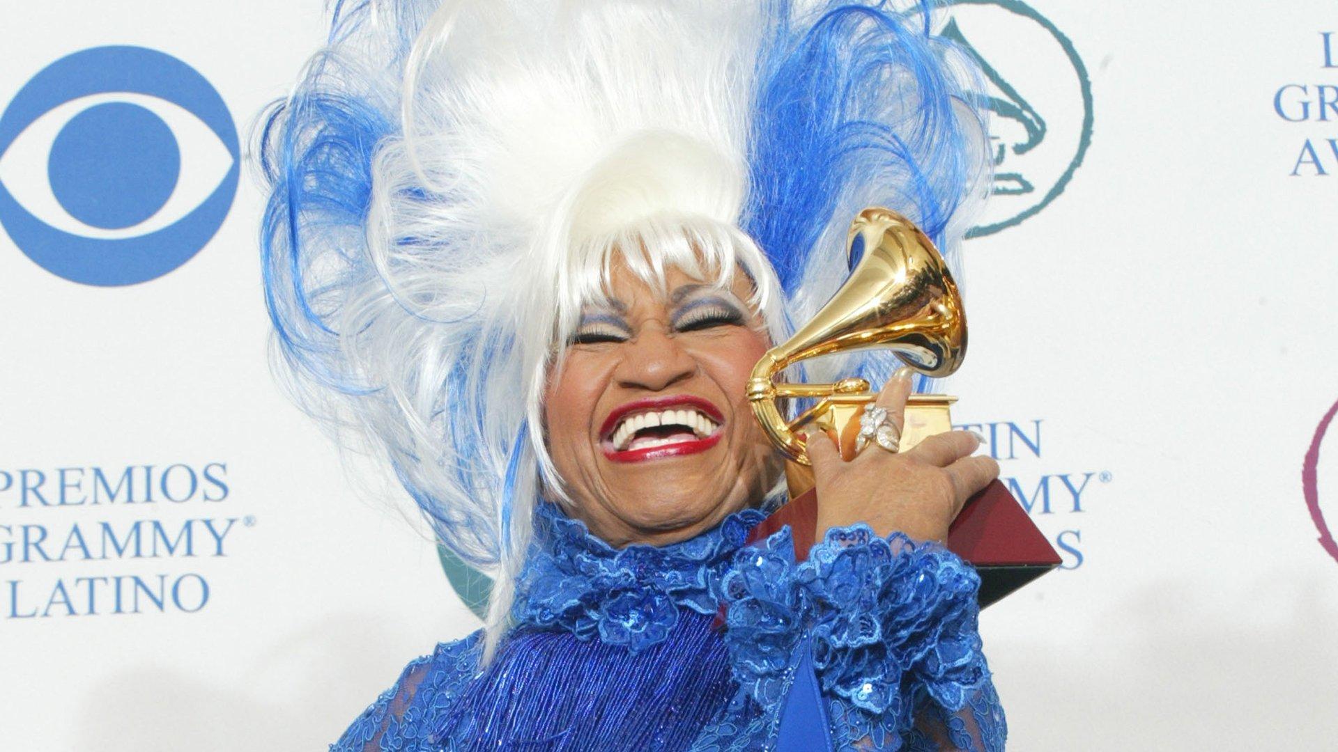 Celia Cruz smiles with her GRAMMY award